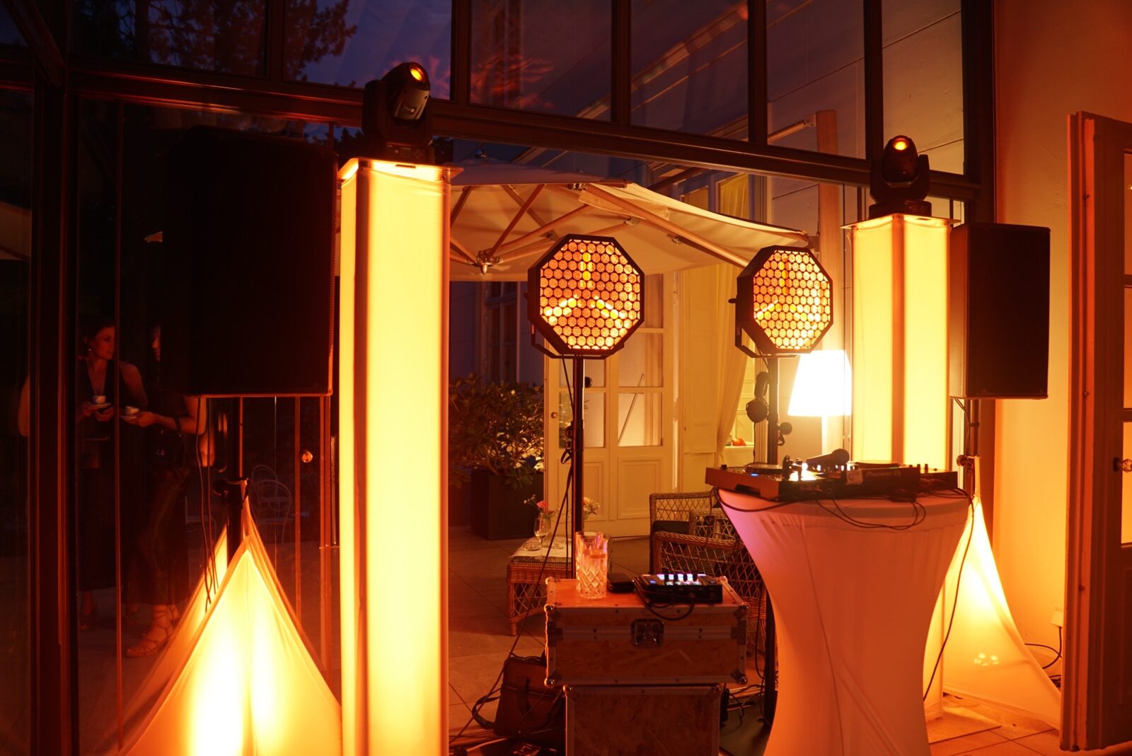DJ-Setup mit Lichttechnik in einer festlichen Orangerie am Abend